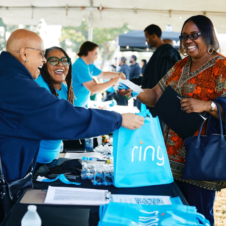 Community members receive Ring products and donations at local events supporting neighborhood safety.