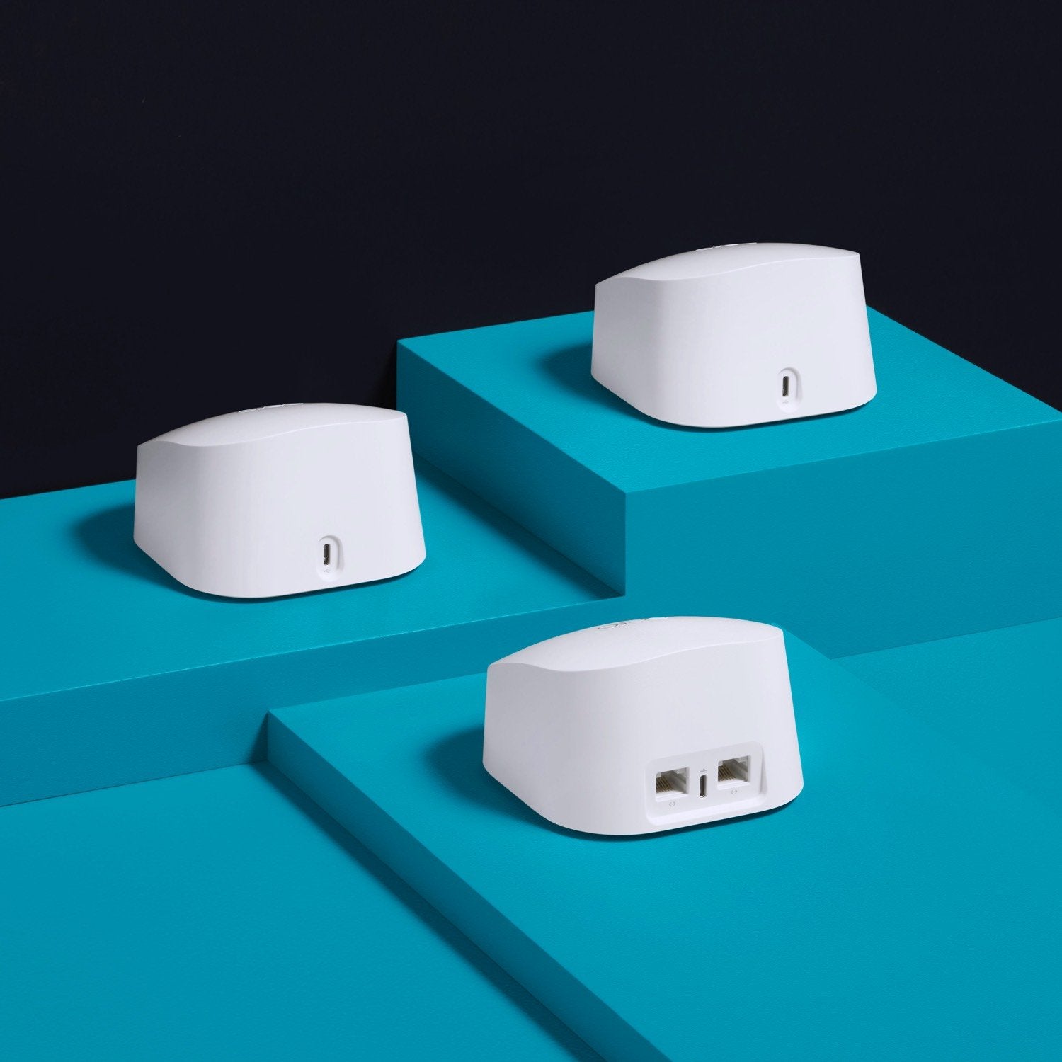 eero 6 Starter Kit - Three white eero 6 devices on blue platforms, showing back ports for Ethernet and USB-C connections.