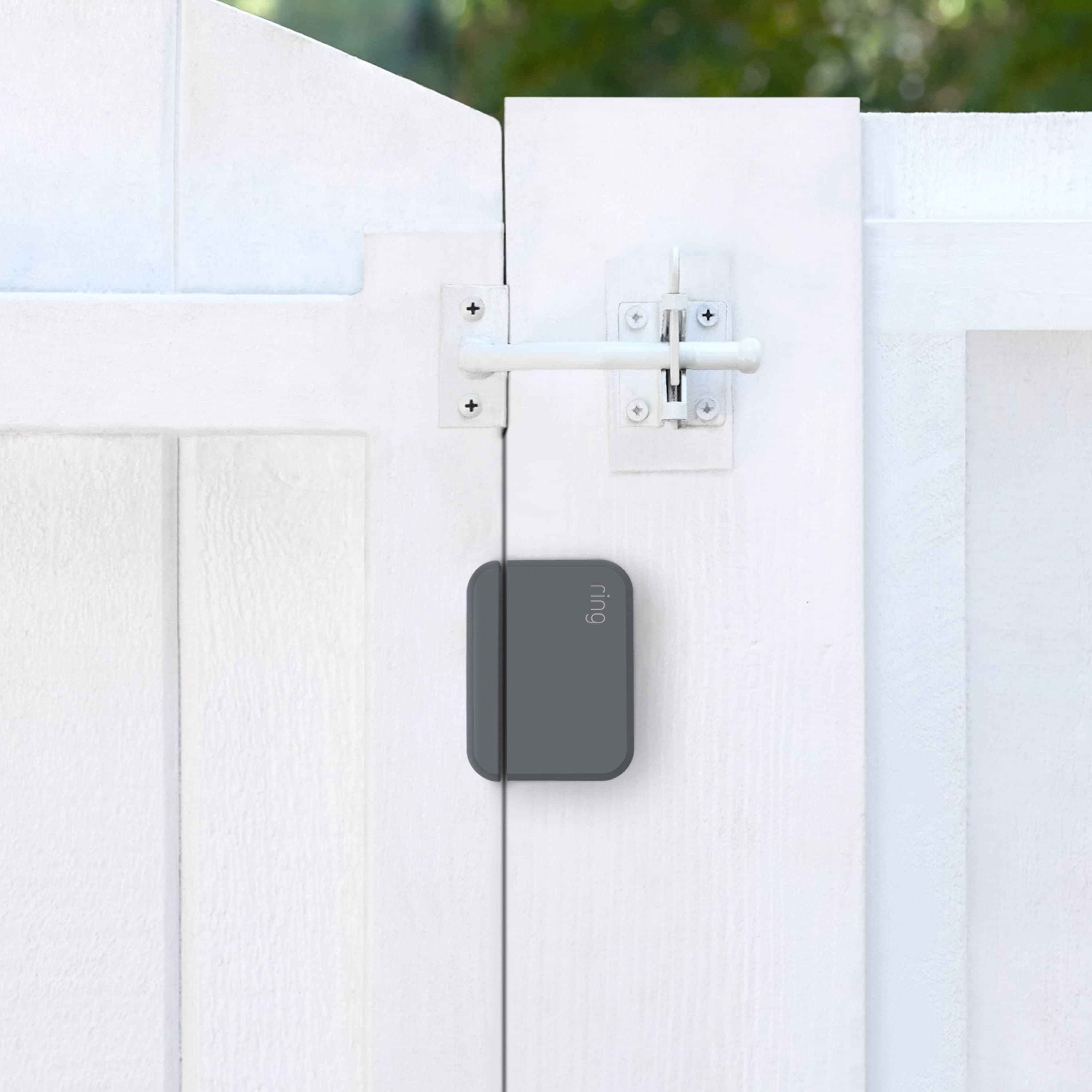Ring Alarm Outdoor Contact Sensor - Black Ring Alarm Outdoor Contact Sensor mounted on a white wooden gate with latch.