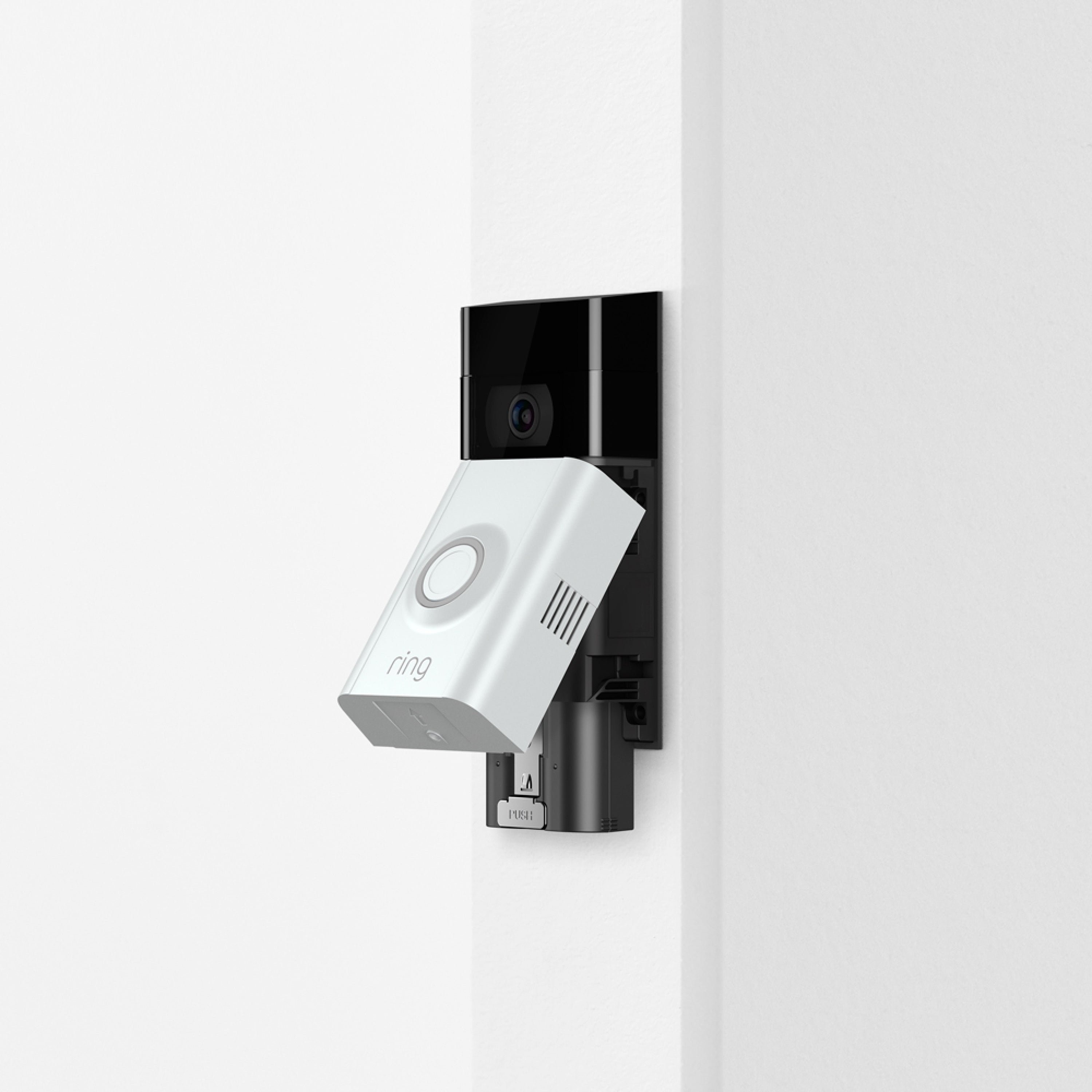 Charging Station + 2 Quick Release Battery Packs - Ring Video Doorbell with Quick Release Battery Pack partially inserted, on white wall.