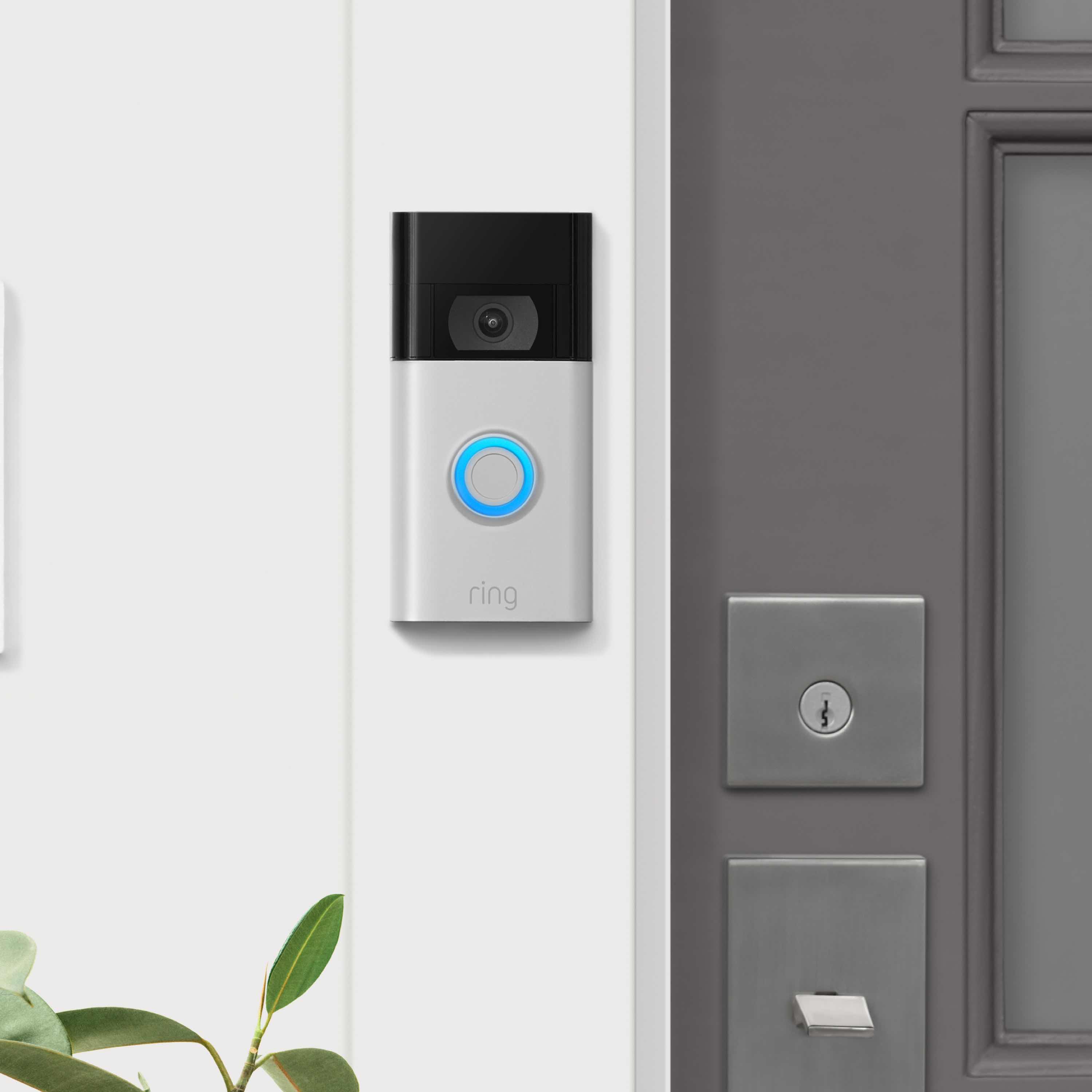 No-Drill Mount (Video Doorbell - 2nd Generation) - Ring Video Doorbell 2nd Gen with blue-lit button mounted next to a grey front door using a No-Drill Mount.
