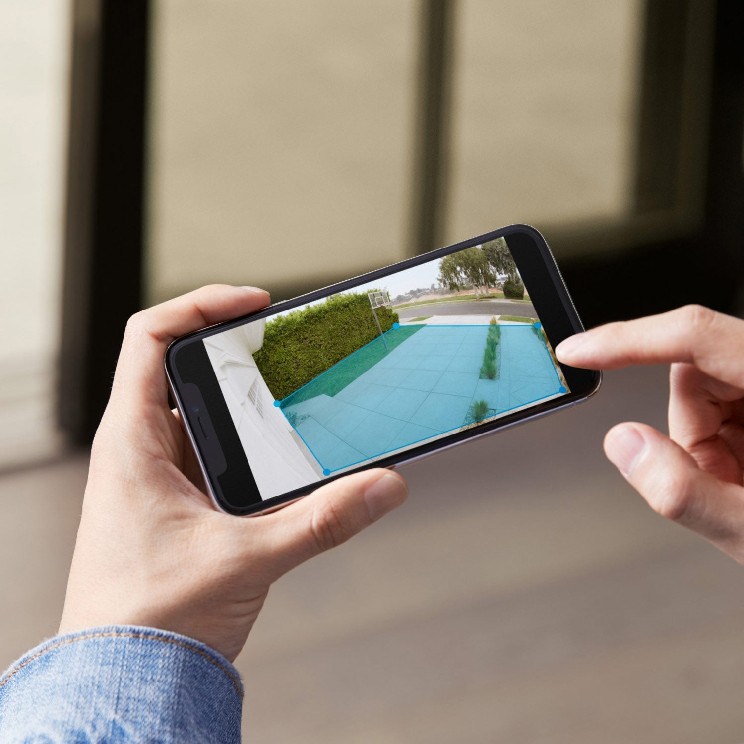 Spotlight Cam Plus - Solar:Ring App showing customizable motion detection zone outlined in blue over a driveway and walkway in daylight.