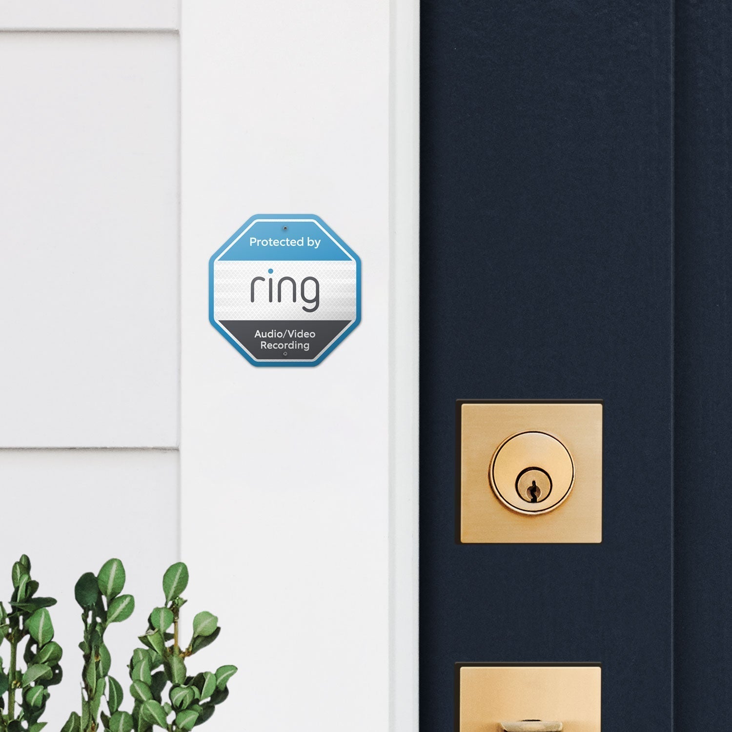 Ring Security Doorplate Sign - Blue and black Ring Security Doorplate Sign on doorframe by front door lock, showing 'Protected by Ring' message.