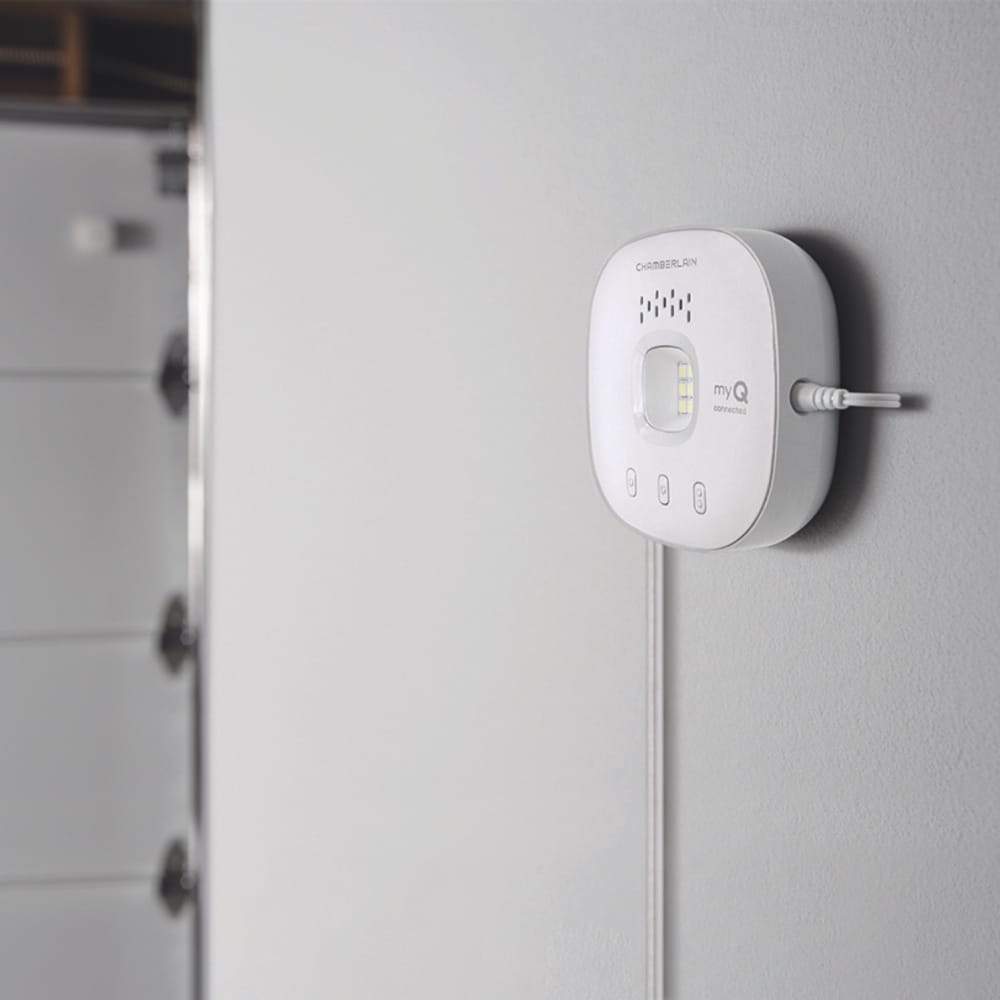 Chamberlain® Smart Garage® Control (for Works with Ring) - White Chamberlain Smart Garage Control device on wall inside garage, showing LED indicators and myQ connected logo.