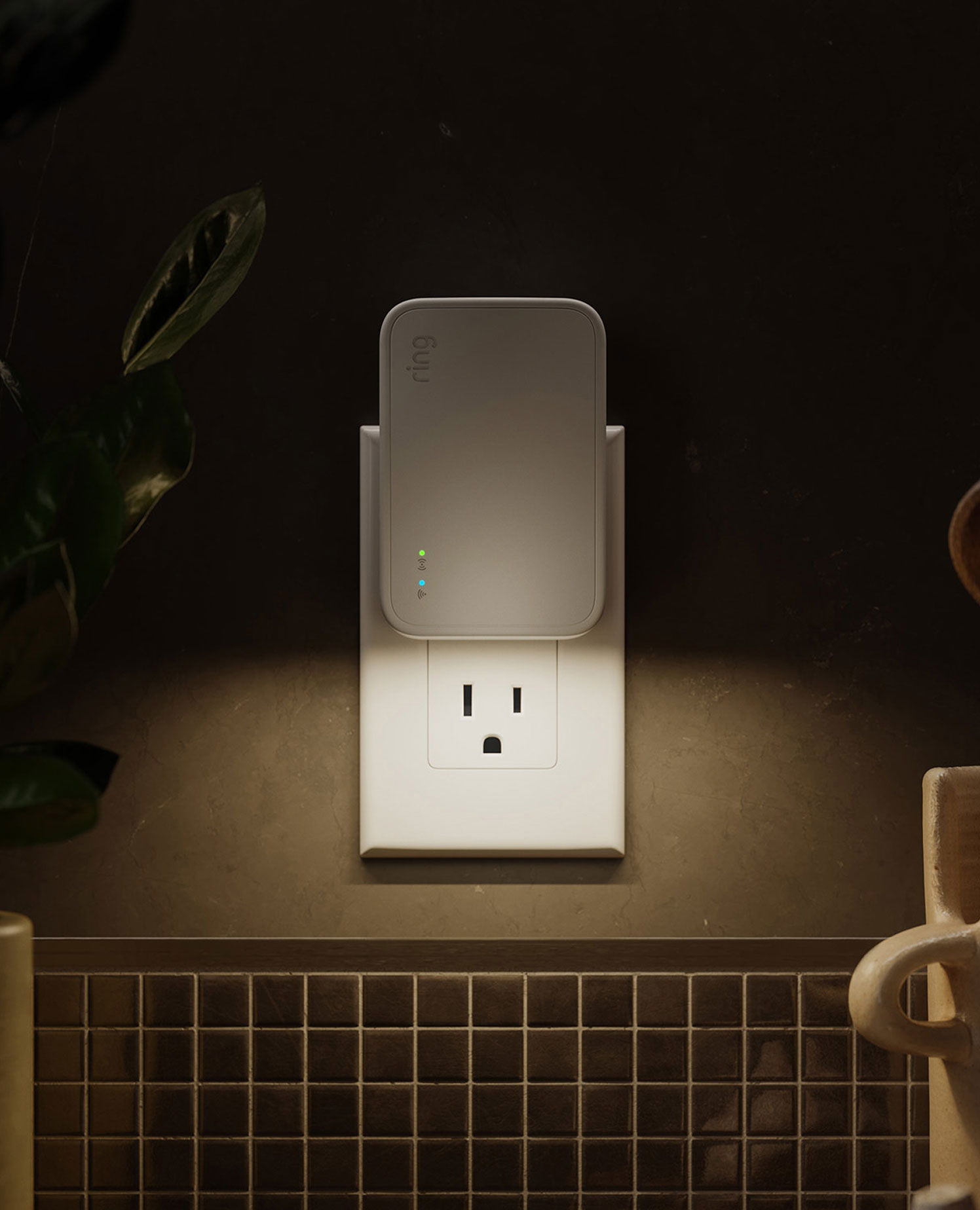 Smart Lighting Bridge (2nd Gen) - Bridge (2nd Gen) plugged into a kitchen outlet. It is emitting a warm light underneath it.