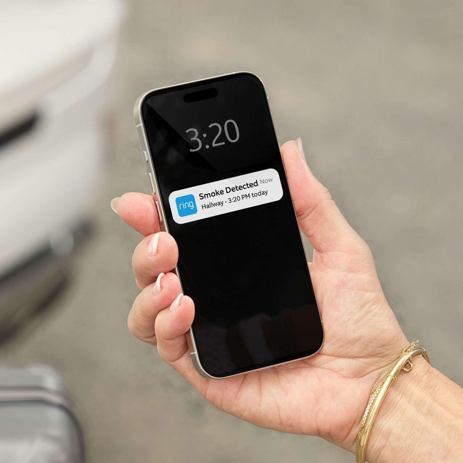 KIDDE Battery Smart Smoke & Carbon Monoxide Alarm  - A hand holds a mobile phone that shows a 