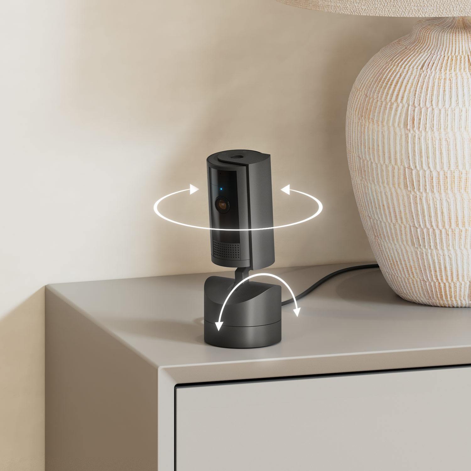 Pan-Tilt Indoor Cam  - Black Ring Pan-Tilt Indoor Cam on table next to lamp, with arrows indicating 360-degree rotation and tilt-adjustment.