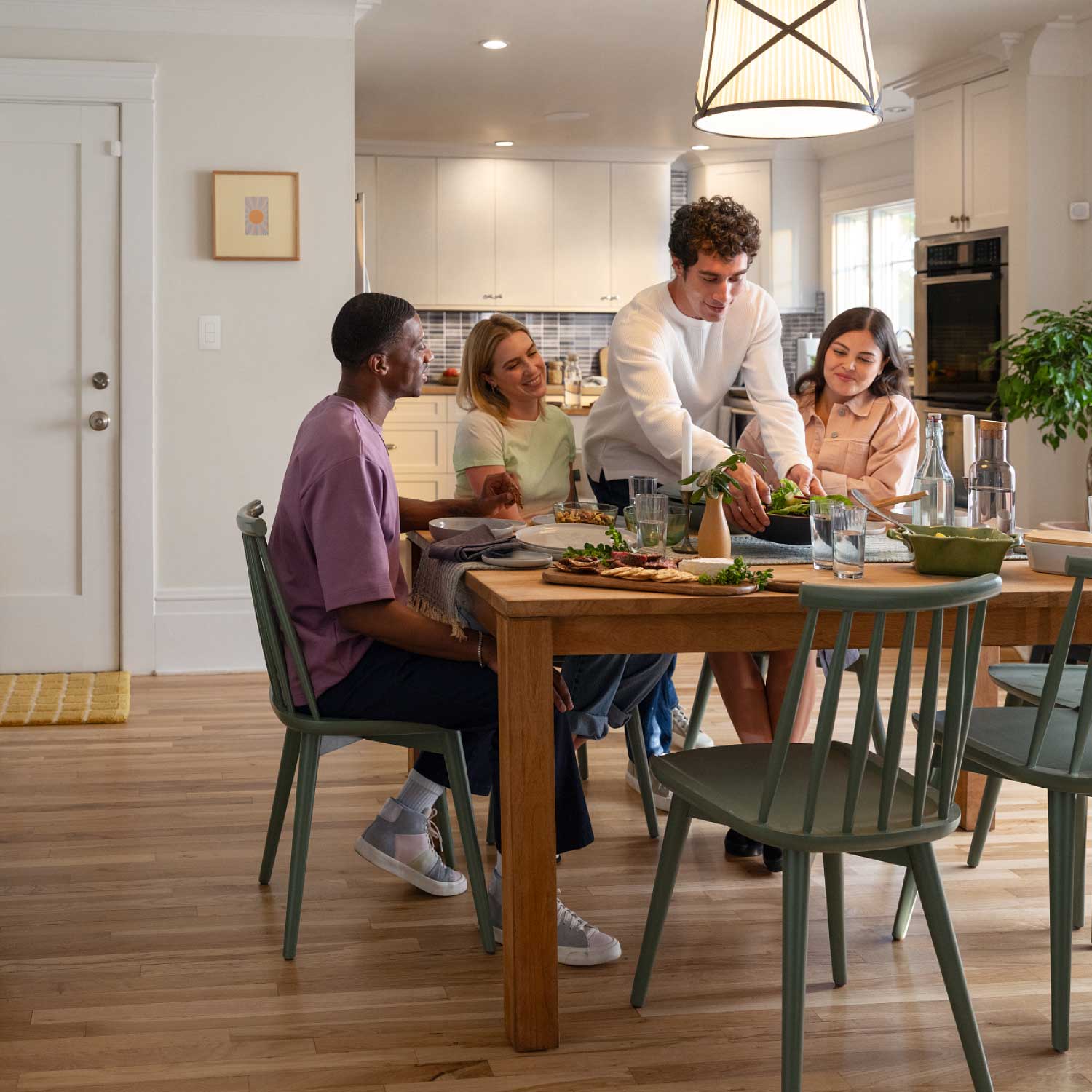 Smart Light Switch (Newest Model) - Smart Light Switch installed on a wall with people gathered. 