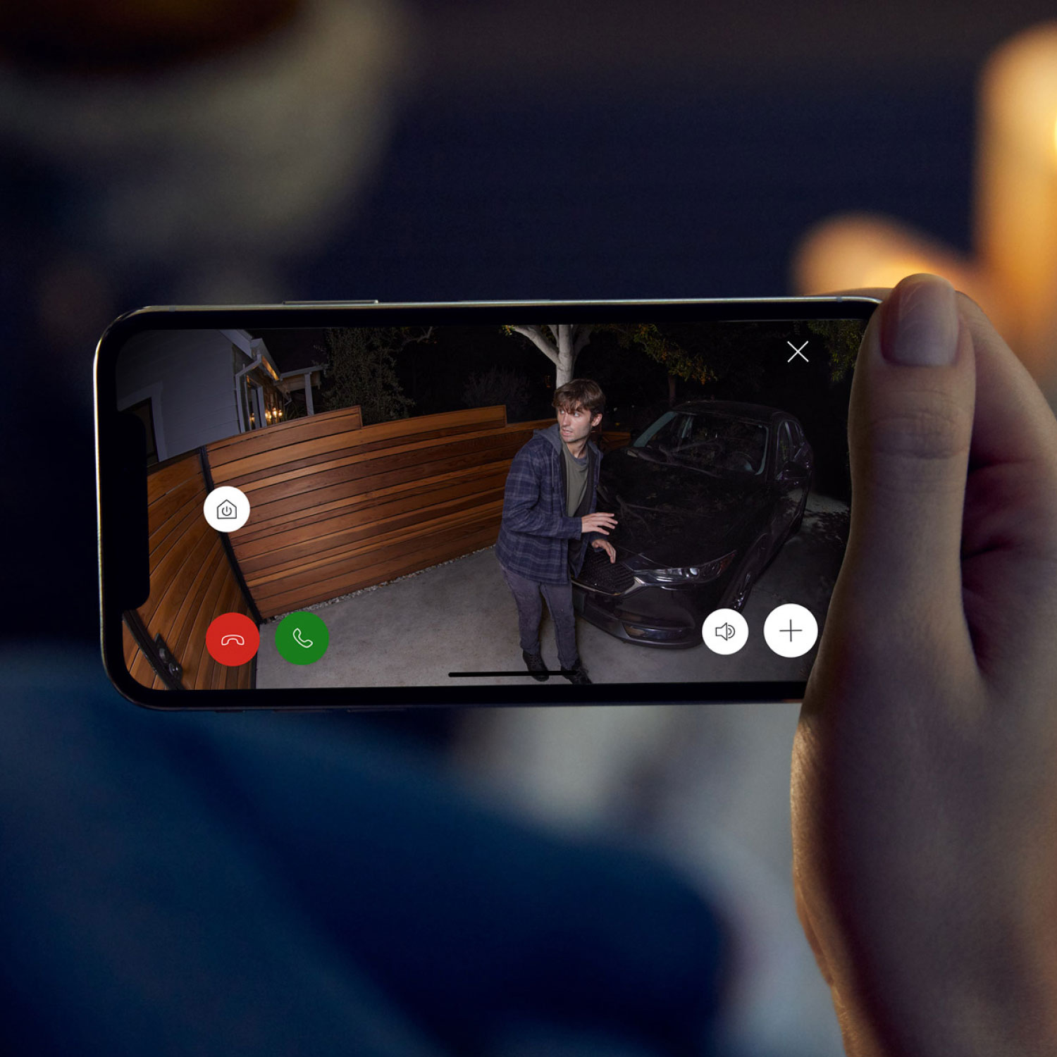 Pan-Tilt Indoor Cam + Spotlight Cam Plus Plug-In - Family using Ring App on smartphone to view home, communicate with visitors, and control connected Ring devices.≥,