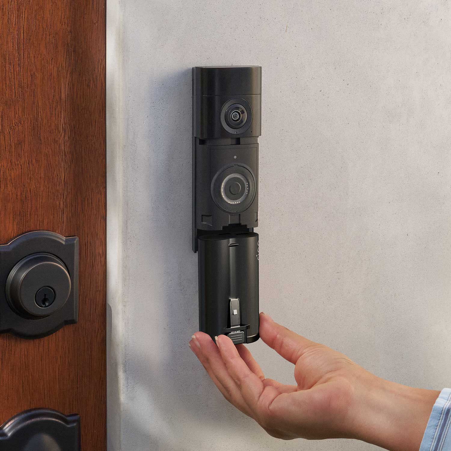 Quick Release Ultra Battery Pack (for Battery Doorbell Plus (Newest Model), Battery Doorbell Pro (Newest Model), Outdoor Cam (Newest Model), and Spotlight Cam (Newest Model)) - Quick Release Ultra Battery Pack being inserted into Ring Battery Doorbell Plus mounted on a wall next to a door.
