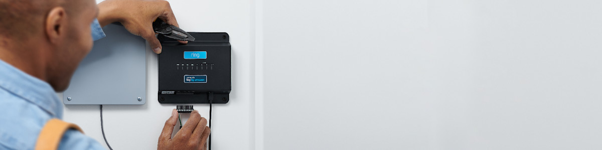 Technician installing smart home control panel on wall