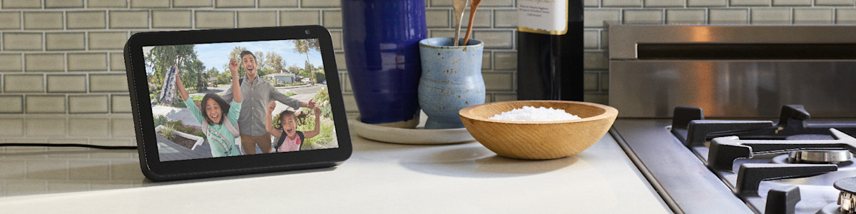 Amazon Echo Show on kitchen counter next to wooden bowl and stovetop