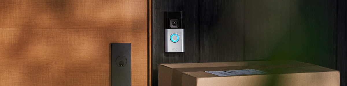 Ring Video Doorbell mounted on wooden door frame with packages below