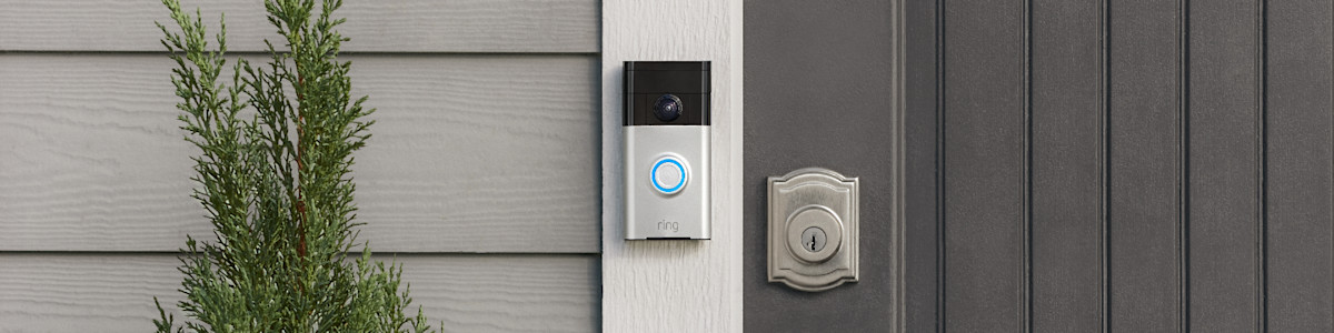 Ring Video doorbell mounted next to front door with decorative lock